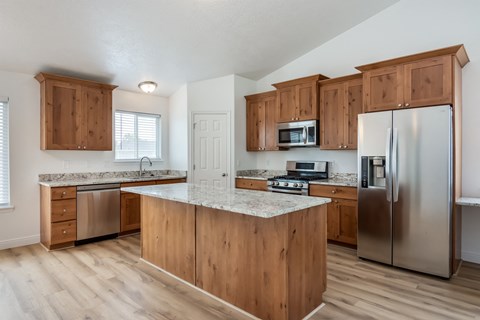 A kitchen with wooden cabinets and stainless steel appliances.