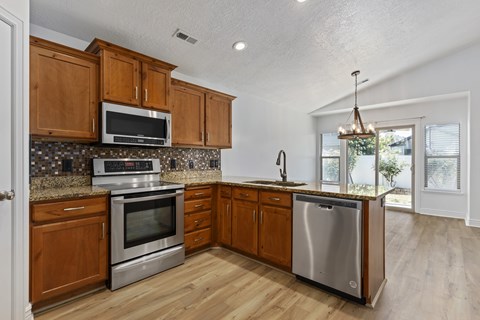A kitchen with wooden cabinets and stainless steel appliances.