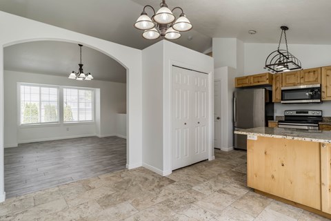 A kitchen with a wooden island and a white door.