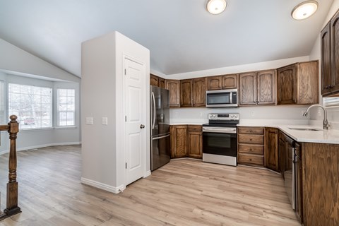 A kitchen with wooden cabinets and a white refrigerator.