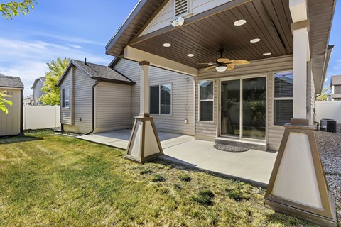 A house with a patio and a ceiling fan.