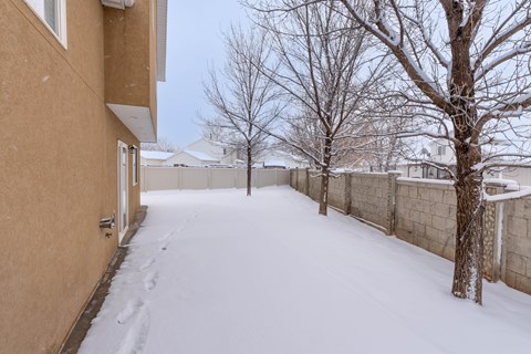 A snow-covered pathway between two buildings.