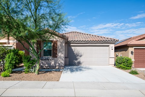 A house with a brown roof and a white garage door.