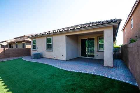 A house with a green lawn in front.