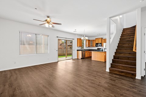 A spacious living room with a staircase leading to the upper floor.