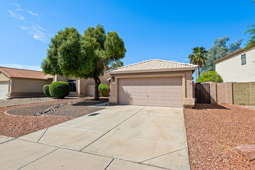 a home with a garage door and a driveway