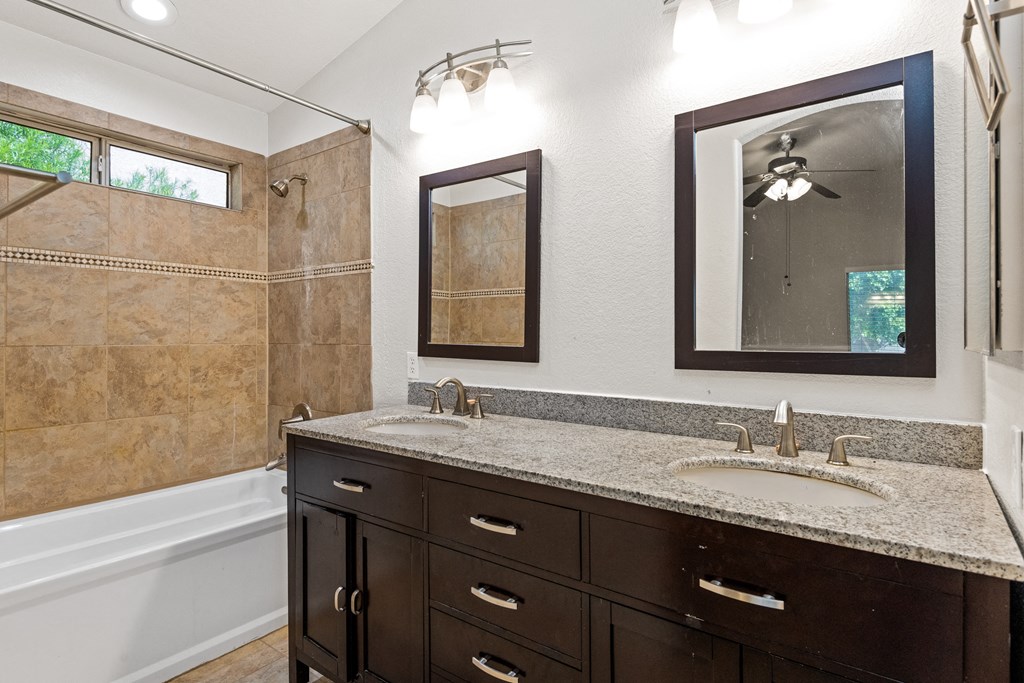 the retreat guest bathroom with granite counter top and shower