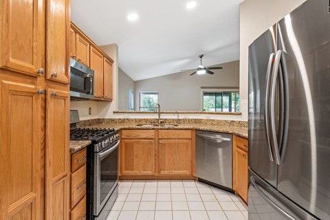 A kitchen with wooden cabinets and stainless steel appliances.