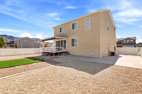 A house with a gravel driveway in front.