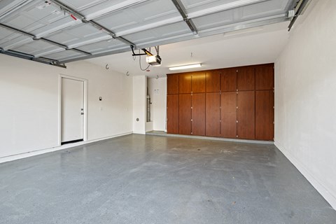 A spacious garage with a concrete floor and a white ceiling.