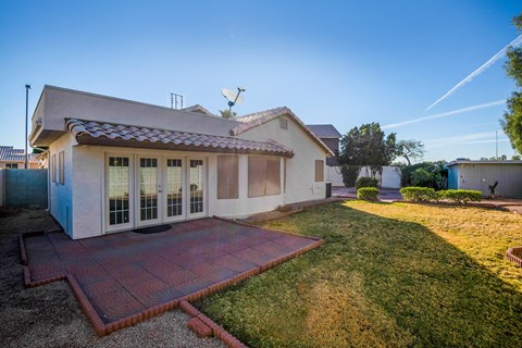 A house with a red brick walkway in front.