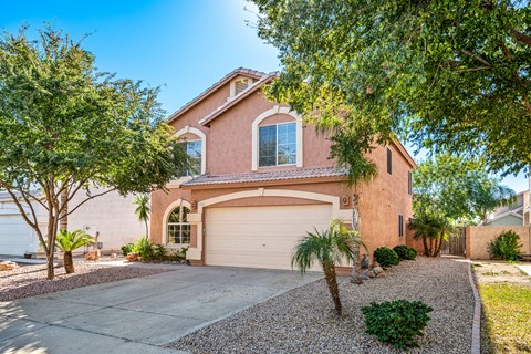 a house with a garage door and a driveway