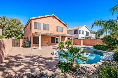 a house with a pool in front of it
