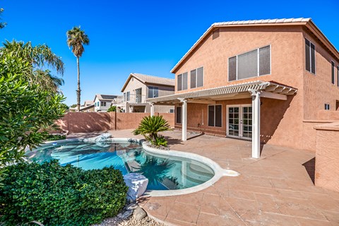 a house with a swimming pool in front of it