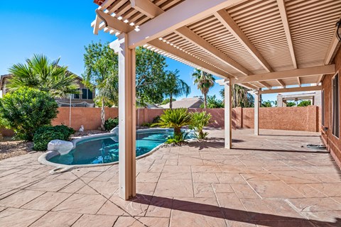 the backyard has a pool and a patio with a pergola