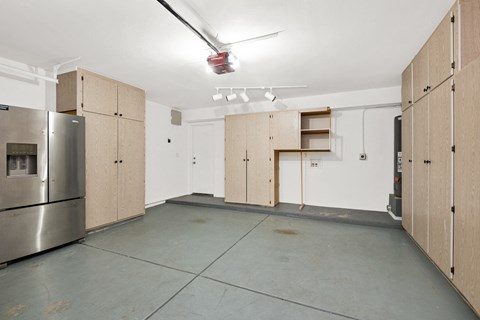 a large kitchen with wooden cabinets and a stainless steel refrigerator