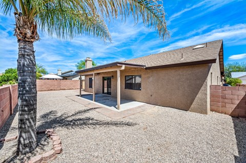 A house with a palm tree in front.