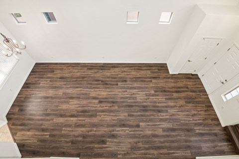 an overhead view of a living room with wood flooring