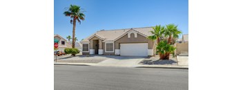 A house with a brown roof and a white garage door.