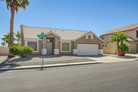 A house with a green sign on the front.