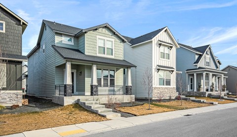 A row of houses with grey and blue exteriors.