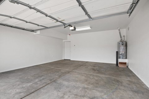 an empty garage with white walls and a concrete floor