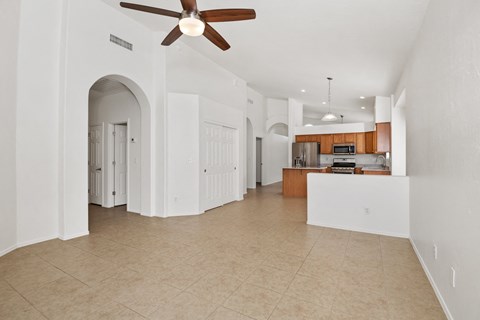 an open kitchen and living room with a ceiling fan