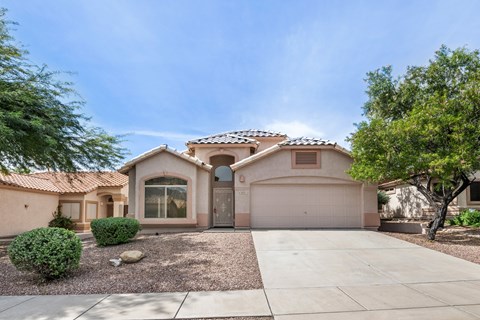 A house with a brown roof and a garage door.