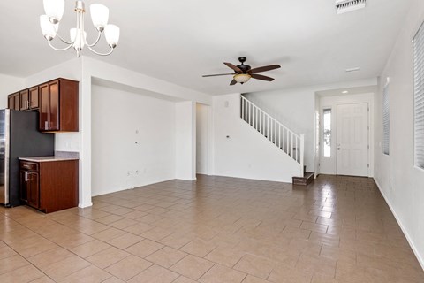A spacious living room with a staircase leading to the upper floor.