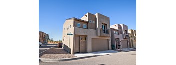 A modern house with a brown facade and a garage door.