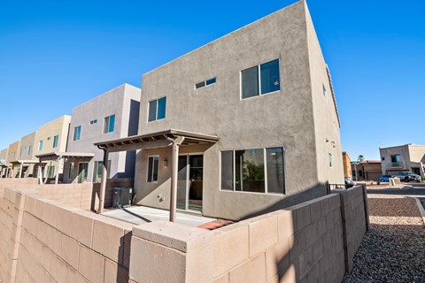 A modern house with a flat roof and a covered entrance.