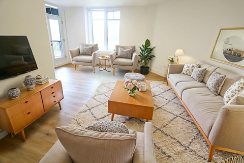 A living room with a sofa, chairs, and a coffee table.
