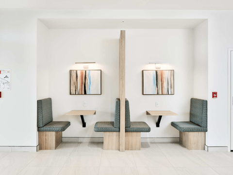 A white room with two tables and four chairs.