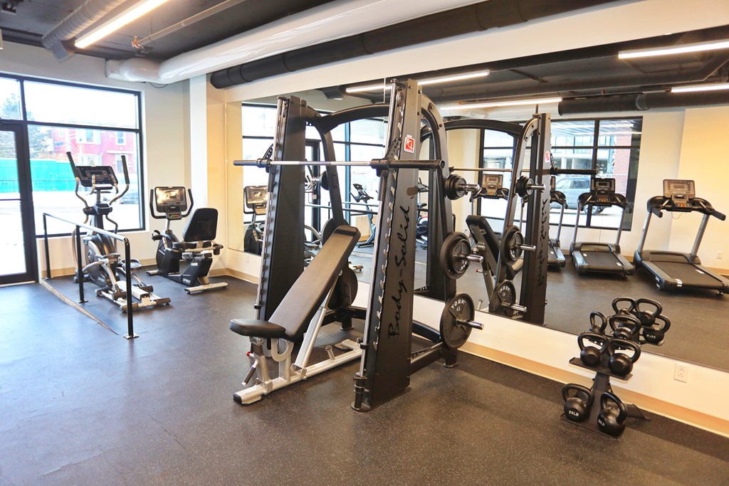 A gym with a variety of equipment including a leg press machine.