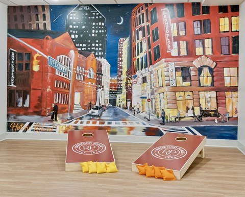 two boxes of popcorn in front of a painting of a city street