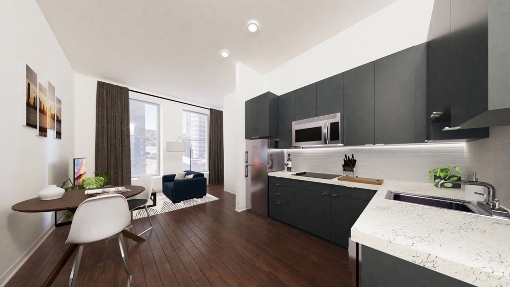a kitchen with black cabinets and a table and chairs