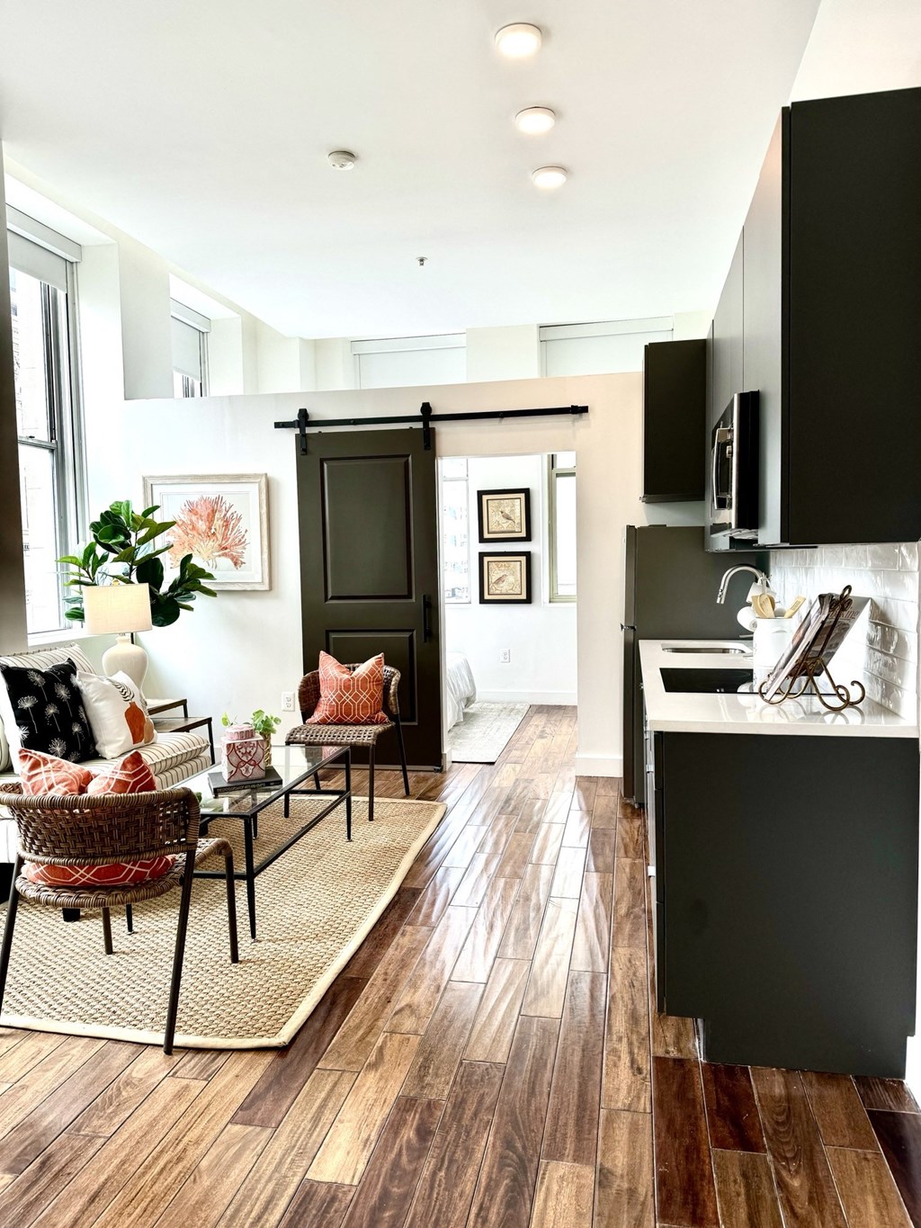 a black and white kitchen and living room with a table and chairs