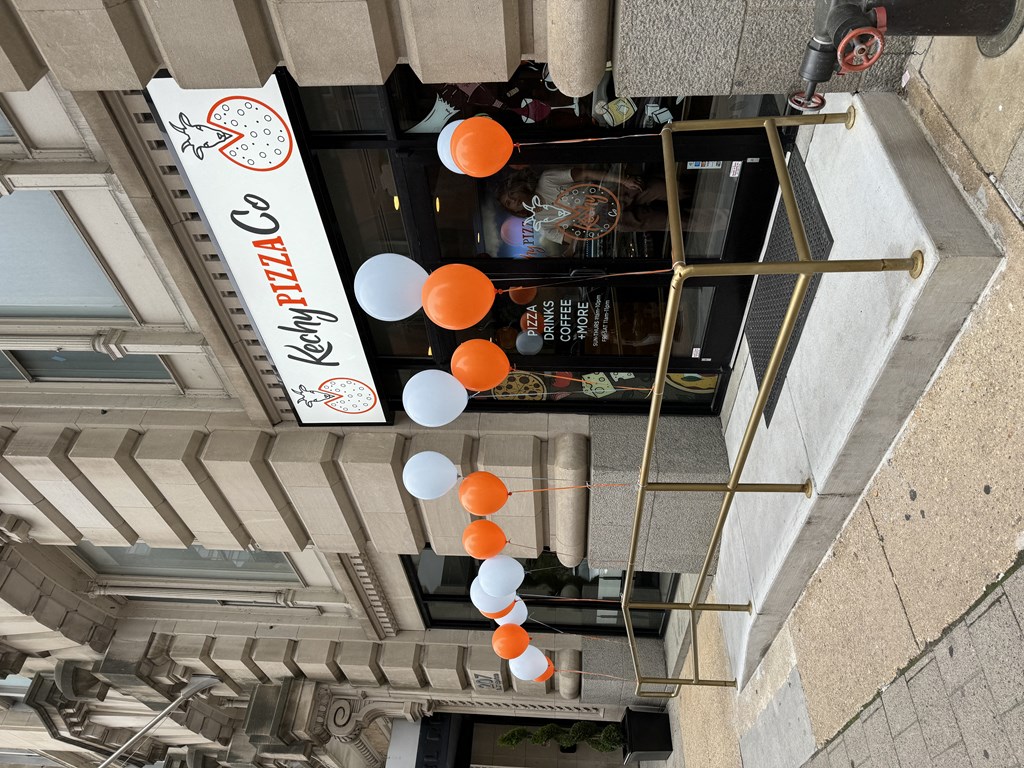 an overhead view of a building with orange and white balloons attached to it