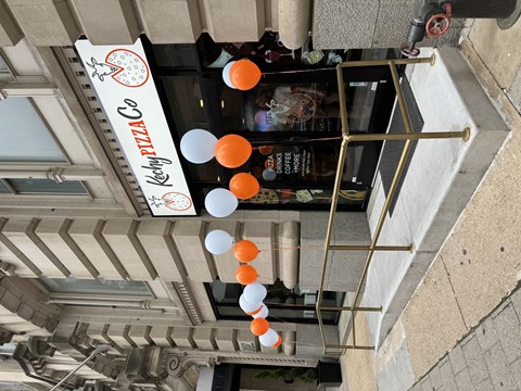 an overhead view of a building with orange and white balloons attached to it