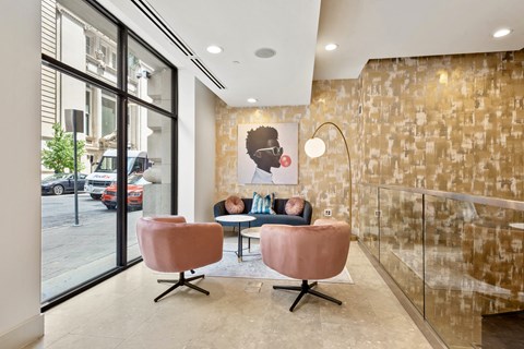 a living room with two chairs and a couch in front of a window