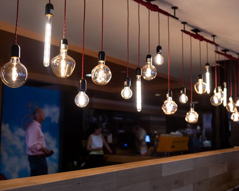 light bulbs hanging from a ceiling above a bar