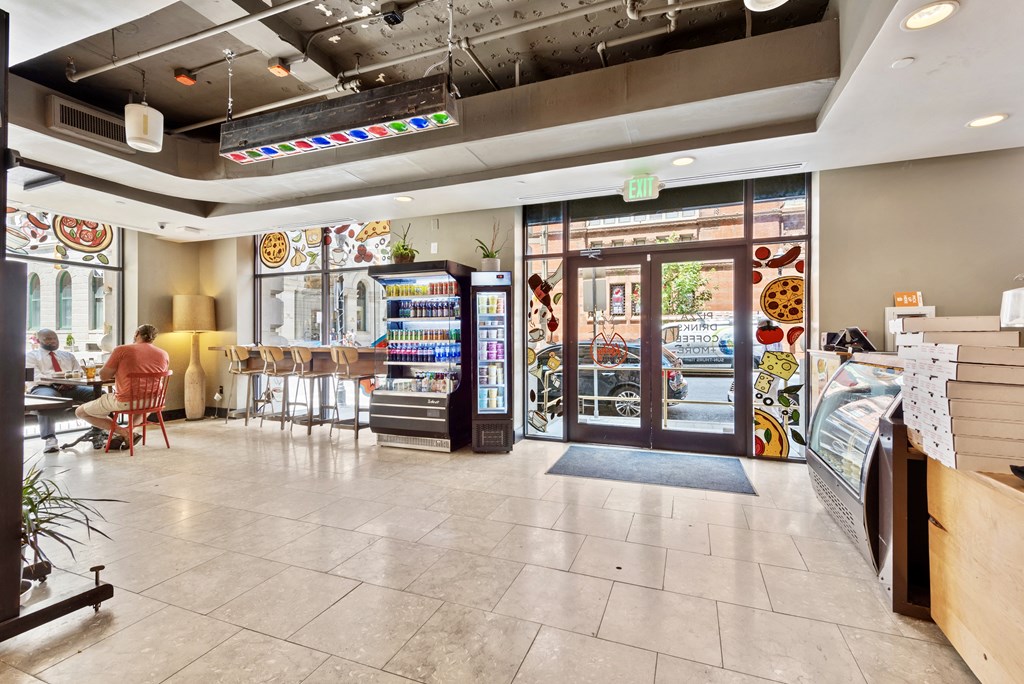 a restaurant with a lobby and a door to a store