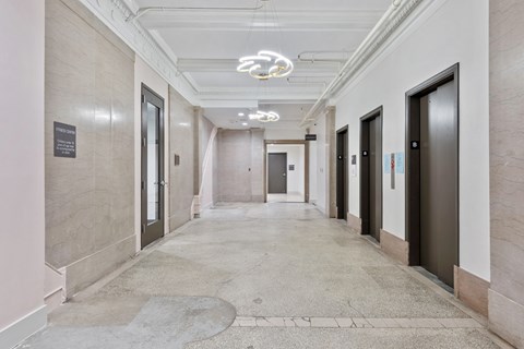 a long corridor with doors in a building