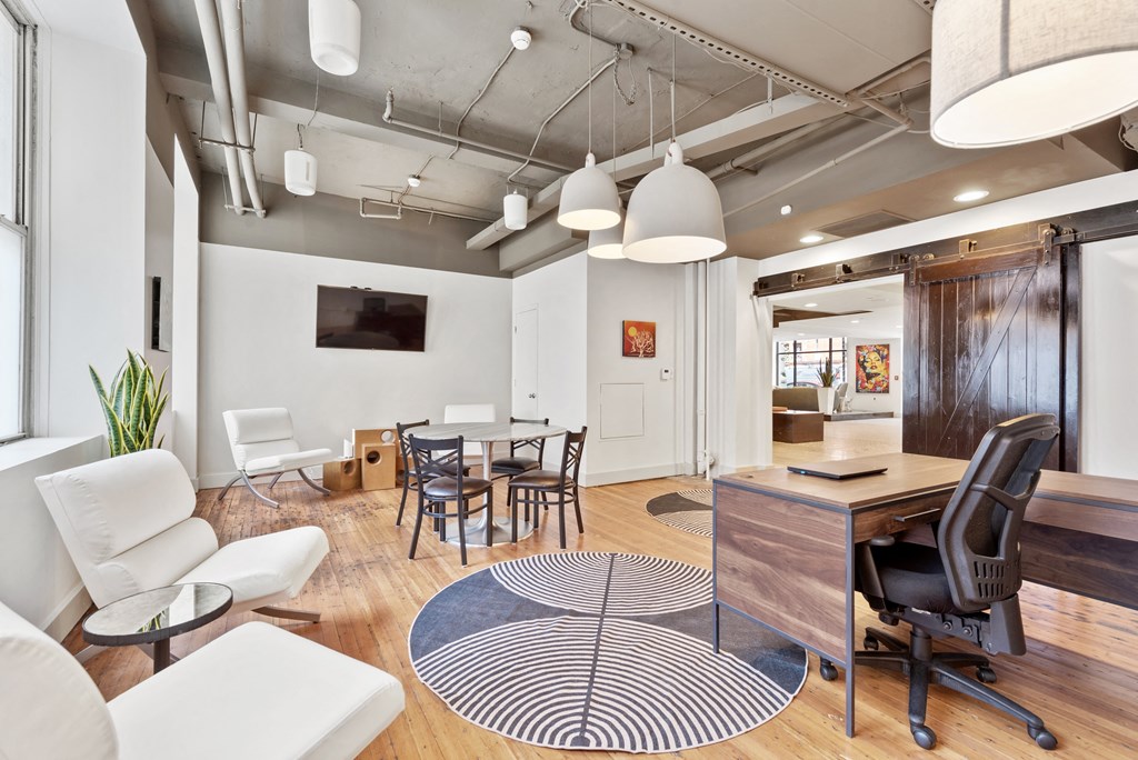 a living room and dining room with a table and chairs
