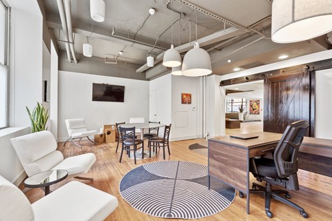 a living room and dining room with a table and chairs
