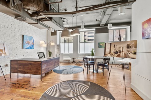 a living room with a dining room and a table and chairs