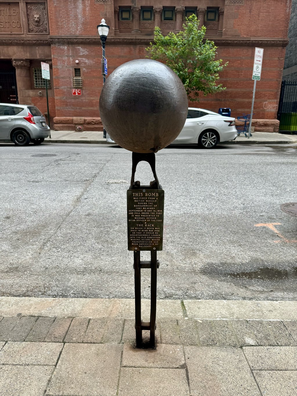 a statue of a globe on a street