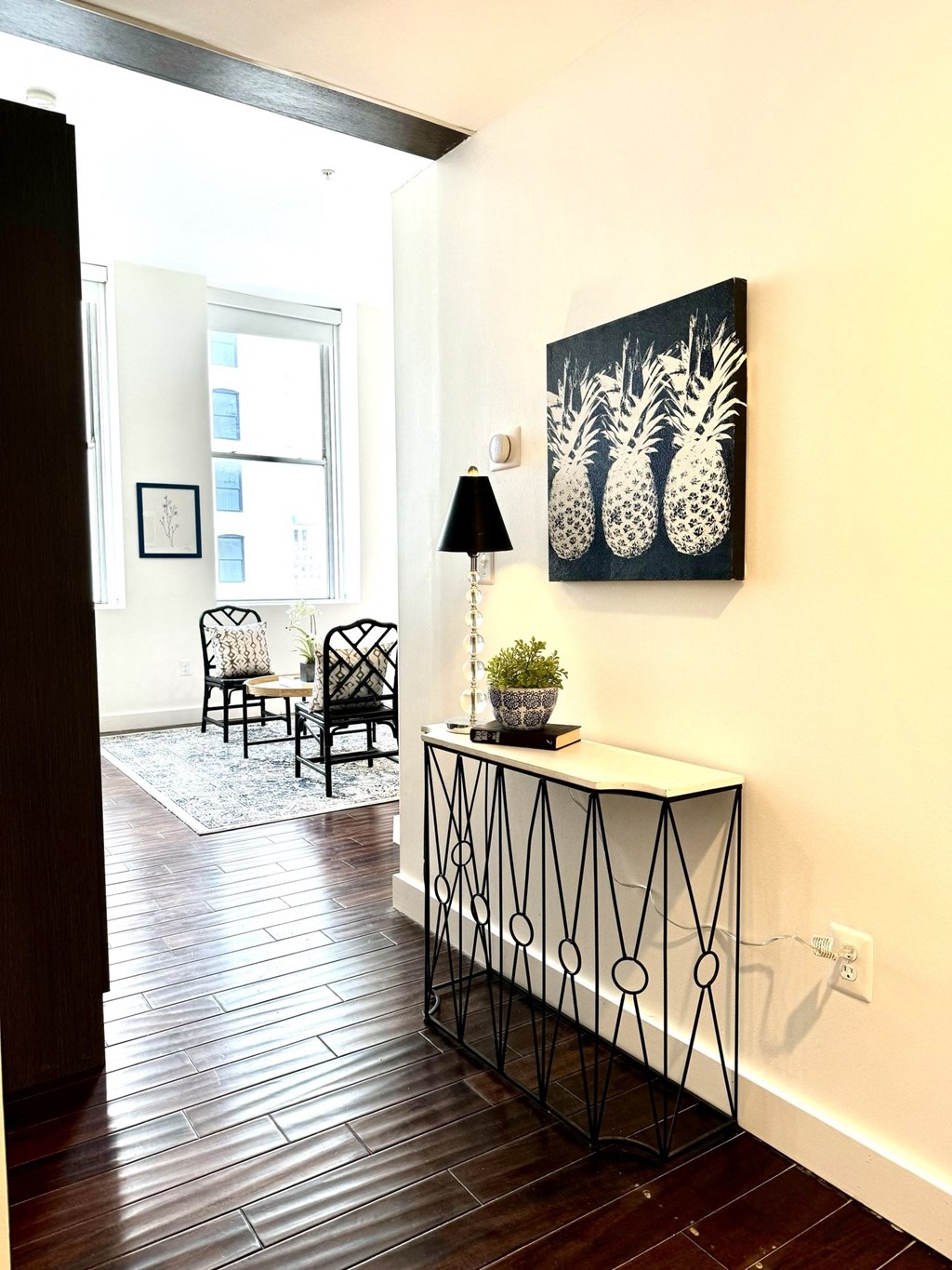 a living room with a table and a painting on the wall