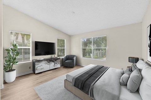 A bedroom with a large bed and a television.