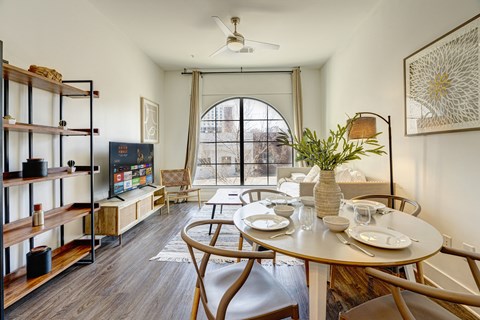 a dining room with a table and chairs and a window
